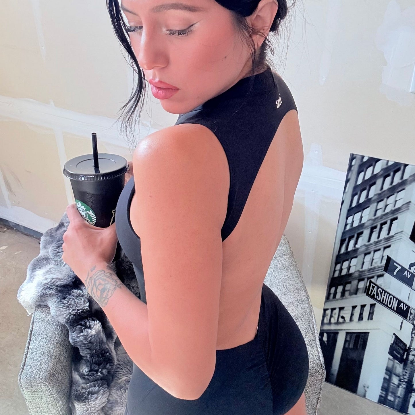Black backless sculpt romper by avvi, curve-hugging fit with scrunch detail and halter neckline, Lounge & Lift Collection.