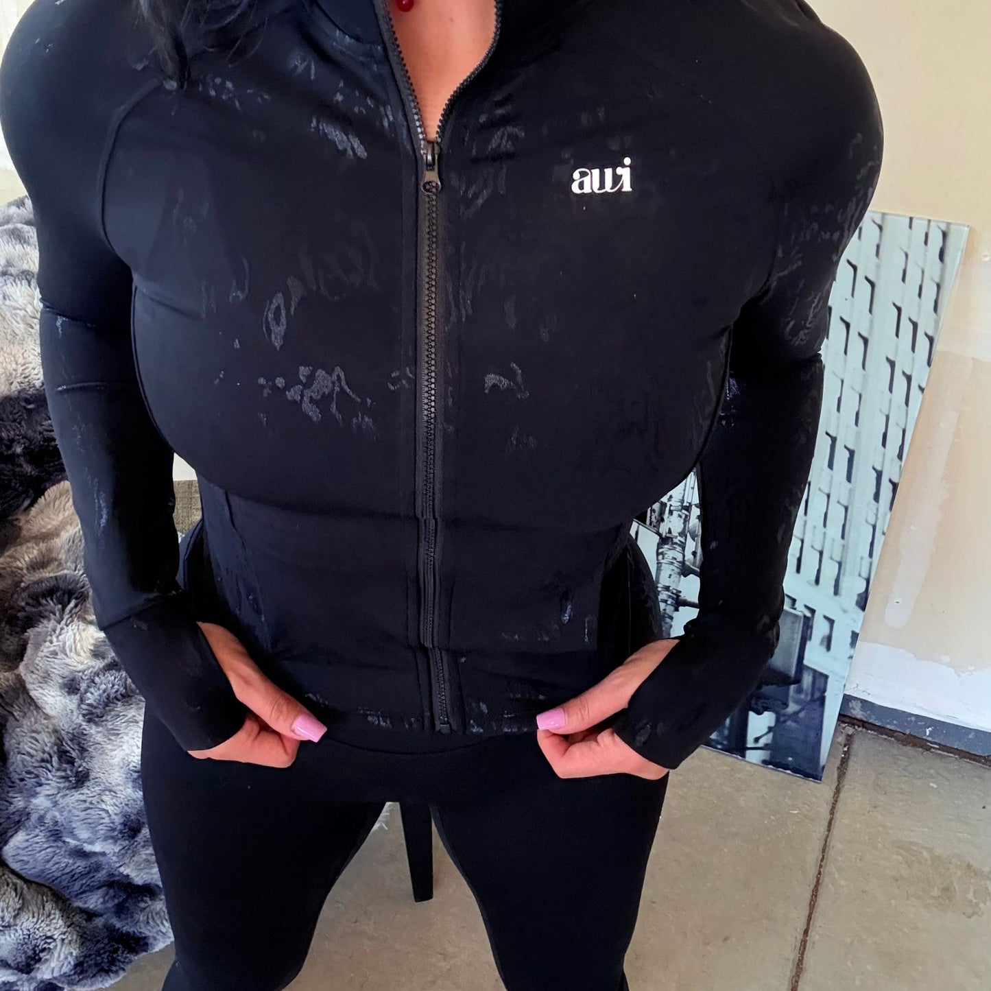 Front detail of Avvi black patterned performance jacket with tonal texture and zipper closure.