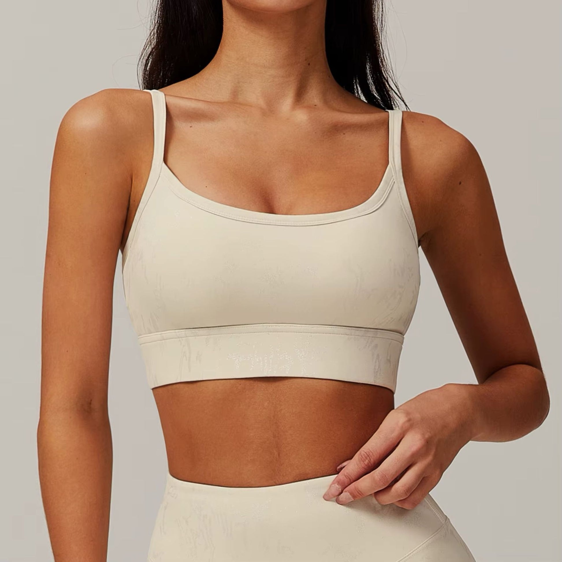 Neutral seamless sports bra by avvi in oat, minimal scoop design with light-to-medium support.