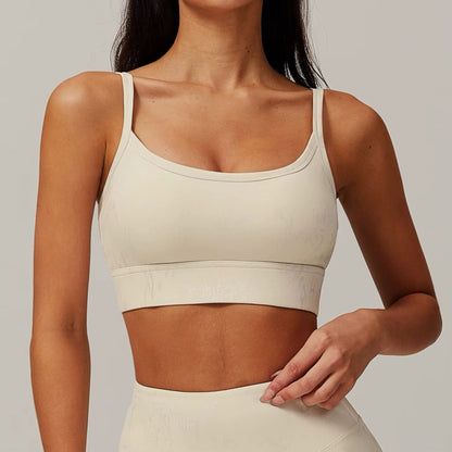 Neutral seamless sports bra by avvi in oat, minimal scoop design with light-to-medium support.