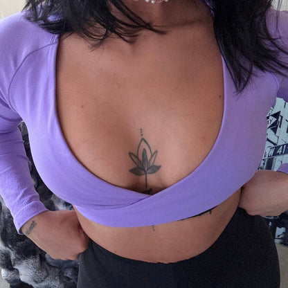Front view of woman wearing the Lilac Studio Layer Crop Top with deep V-neck and long sleeves, paired with Avvi’s black V-Neck Scrunch Leggings.