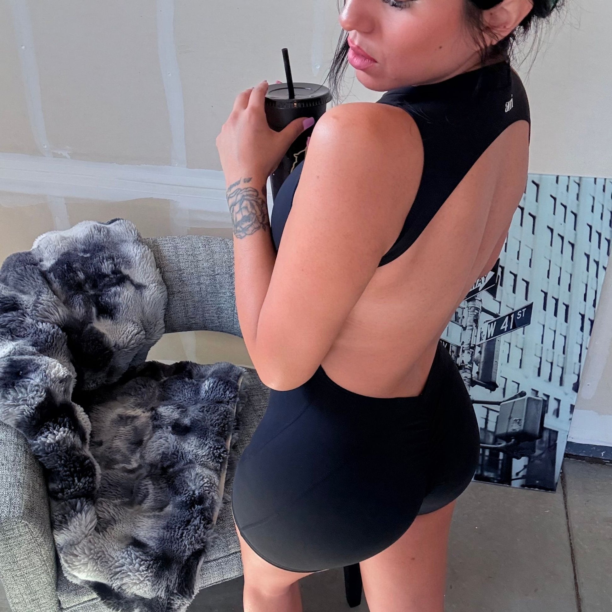 Black backless sculpt romper by avvi, curve-hugging fit with scrunch detail and halter neckline, Lounge & Lift Collection.