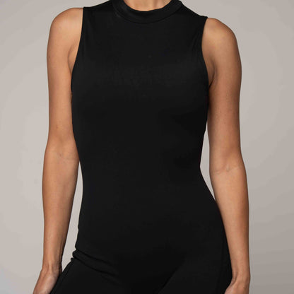 Black sleeveless top worn by a person on a neutral background