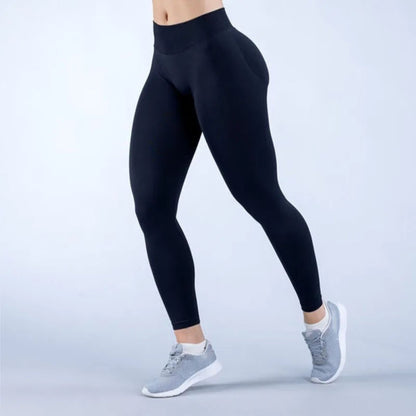 Person wearing black leggings and gray sneakers on a light gray background